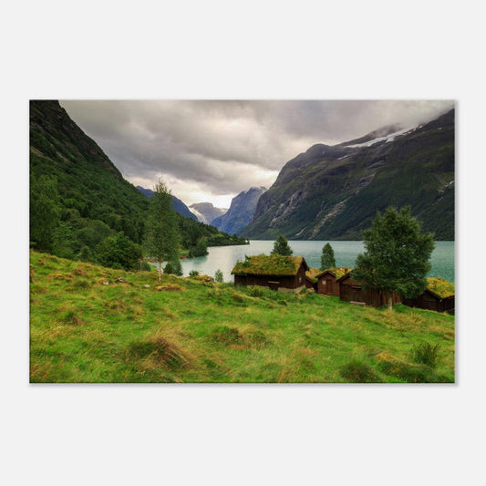 Pastoral scene of Lodalen Valley featuring rustic cabins nestled by calm blue waters and lush green meadows on canvas.