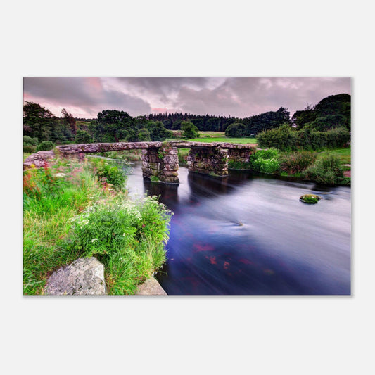 Historic stone clapper bridge over river in Dartmoor, Devon