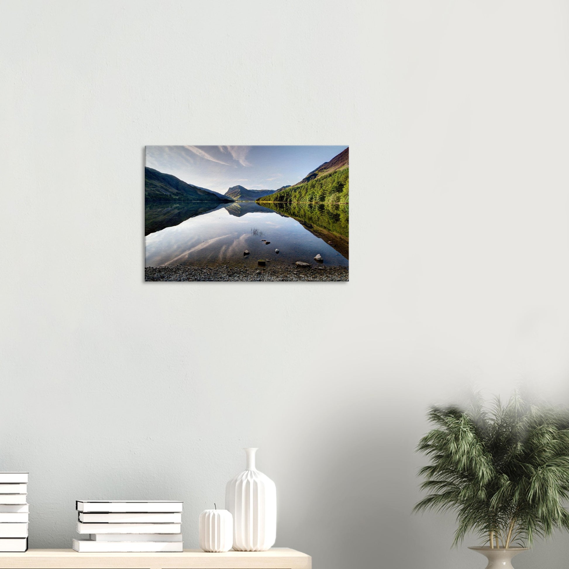 Canvas print capturing Buttermere Lake at sunrise with perfect water reflections, dramatic fells, and flecks of light on rocky slopes.