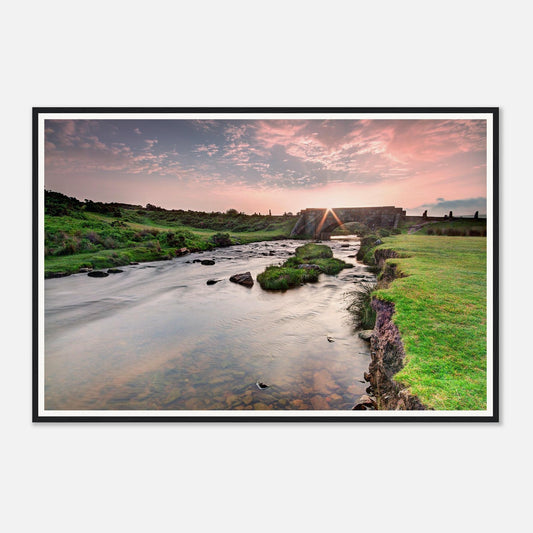 Tranquil Dartmoor dawn scene with river and ancient bridge