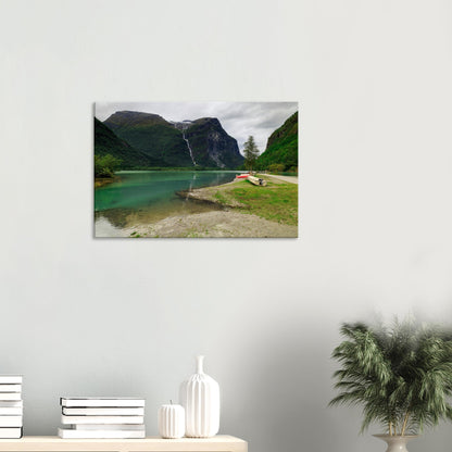 Scenic view of Norway’s Mount Ramnefjell beside the sparkling waters of Utigardsfossen Waterfall and emerald lake