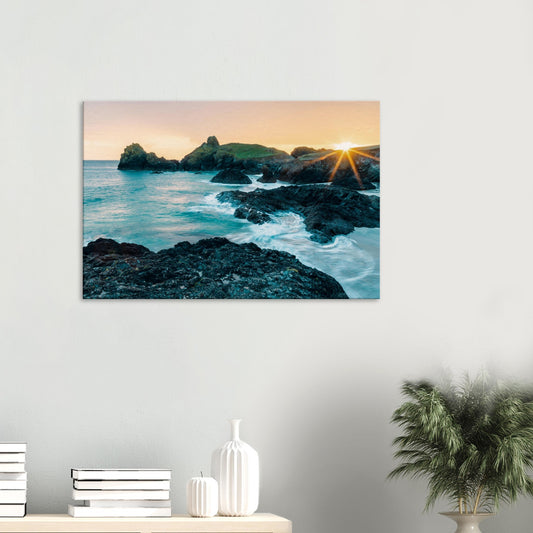 Sunset over Kynance Cove with golden light illuminating the dramatic Cornish cliffs