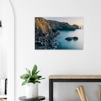 Idyllic golden hour light enveloping Mullion Cove’s cliffs and beach in calm serenity