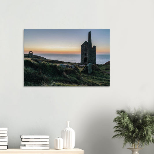 Silhouetted ruins of Wheal Owles engine house glowing at golden hour on the Cornish coastline