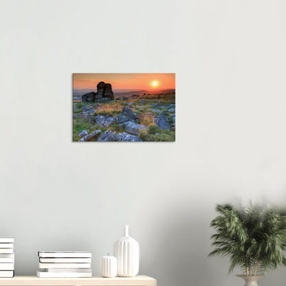 Dramatic Dartmoor sunset showcasing the warm interplay of light and shadow on rocky terrain
