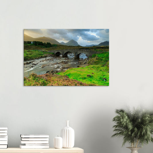 Canvas print of Sligachan Old Bridge on the Isle of Skye with river, rocks, and Cuillin mountains in the background.