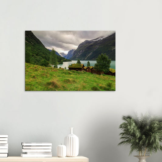 Canvas print showcasing Norway’s Lodalen Valley with traditional grass-roofed cabins by a turquoise lake and towering mountain cliffs.