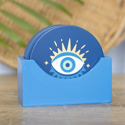 All Seeing Eye Coaster Set with four mystical designs in a matching blue holder, perfect for quirky home décor.