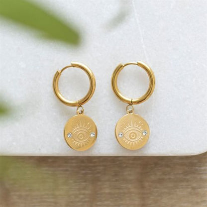 Gold-toned All Seeing Eye Earrings made from stainless steel, symbolising protection and good luck, presented on a printed meaning card.