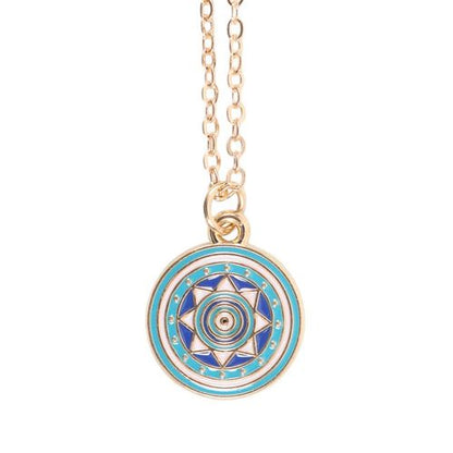 Gold-tone all seeing eye necklace on turquoise card with star accents and matching dark blue envelope.