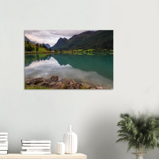 Canvas print featuring Norway’s Lake Floen with calm reflective waters and towering mountains in the background.