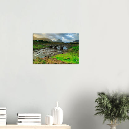 Canvas print showing Sligachan Old Bridge arching over a river with Skye’s iconic Cuillin range beyond.