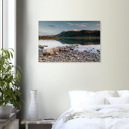 Bassenthwaite Lake shoreline with stones in foreground and calm reflections