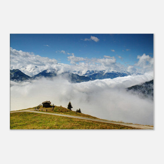 Canvas print capturing the peaceful isolation of a mountain hut above a sea of clouds in the Austrian Alps with distant panoramic peaks.