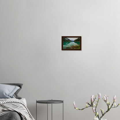 Framed canvas of calm lake with cloudy sky and green slopes