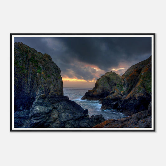 Rugged cliffs at Mullion Cove with evening light in Cornwall