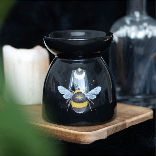 Mystical black oil burner with forest bee design, moon and star accents, and tealight holder.