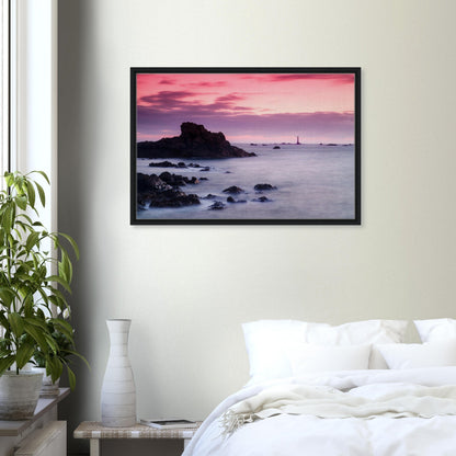 Framed wall art of lighthouse with pastel skies and coastal rocks