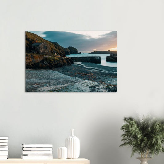 Long exposure image of Mullion Cove harbour with calm, silky sea at twilight