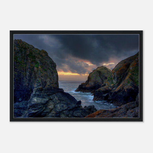 Sunset light on rugged cliffs at Mullion Cove framed canvas