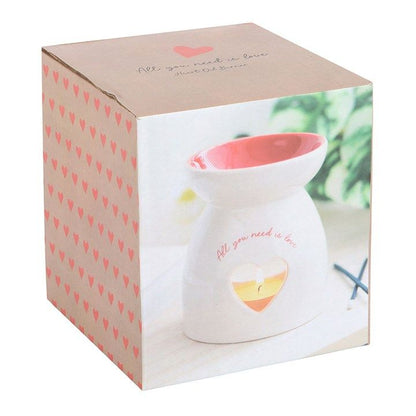 White ceramic oil burner with heart cut-out and "All you need is love" text, perfect for romantic and heartfelt gifting.