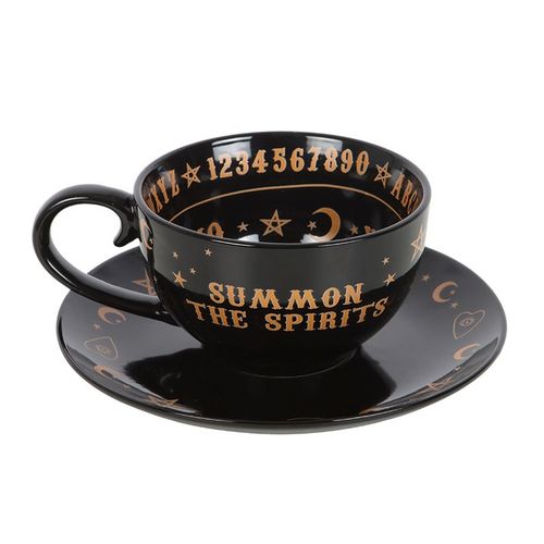 Ceramic teacup and saucer set with mystical talking board design in black and gold finish, perfect for tea leaf reading.