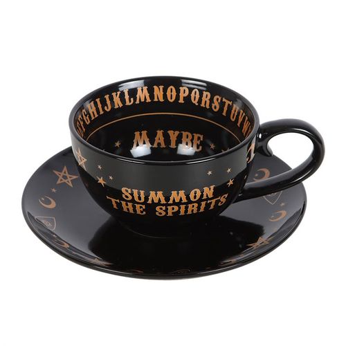 Ceramic teacup and saucer set with mystical talking board design in black and gold finish, perfect for tea leaf reading.