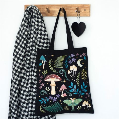 Black cotton canvas tote bag featuring an ethereal dark forest design with mushrooms, luna moth, and magickal plants.