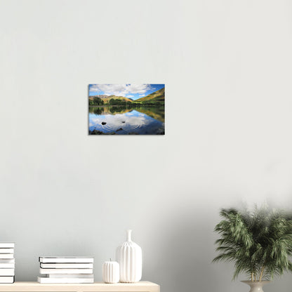 Buttermere Lake canvas showing gentle surface ripples and partial reflections of clouded sky and vibrant hills in soft, natural light.