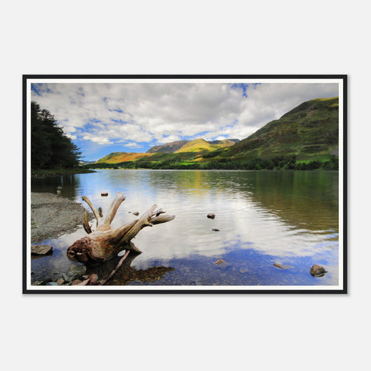 Calm waters of Buttermere reflecting clouds and green fells