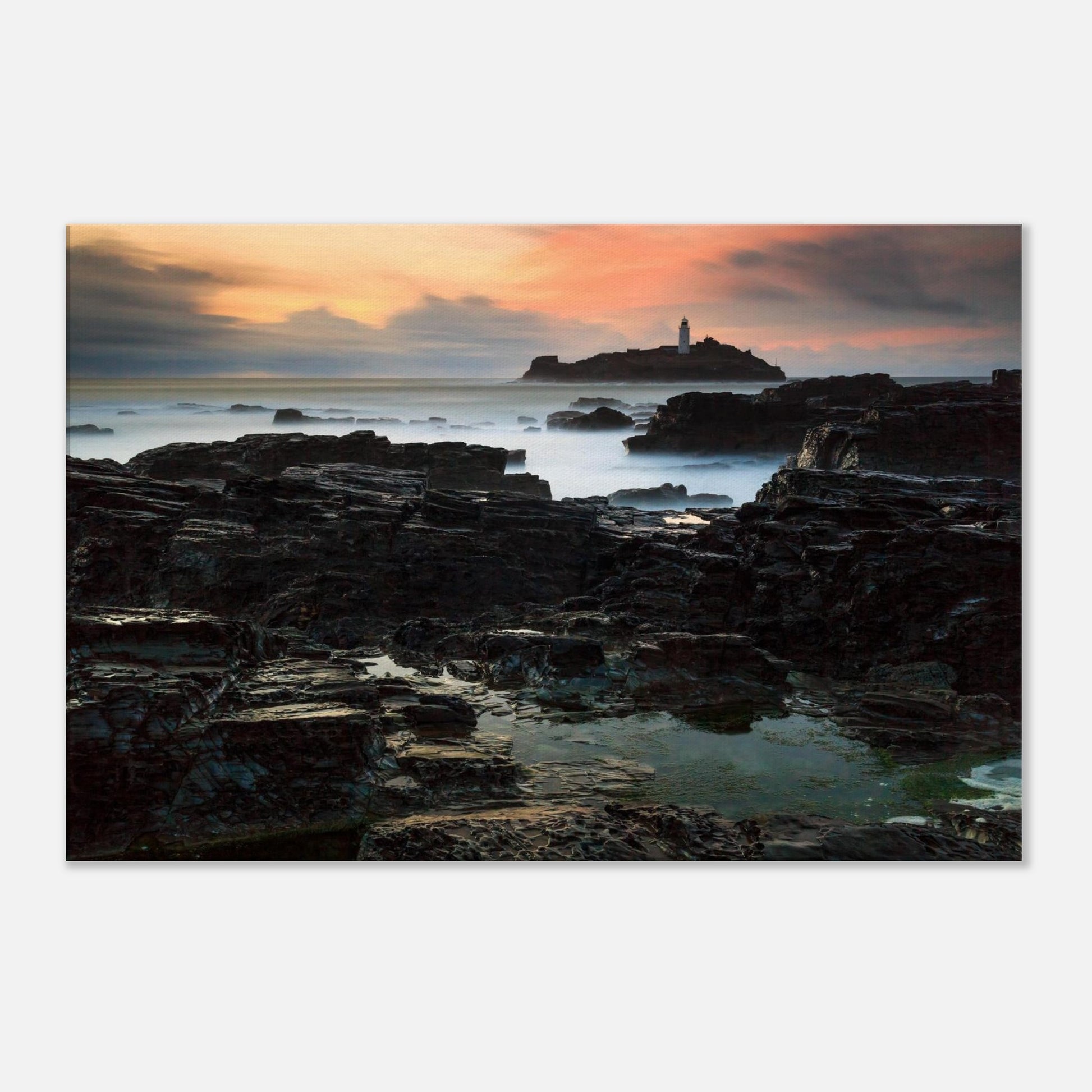 Cornwall lighthouse at dusk captured in canvas artwork with vibrant skies and rugged shoreline.
