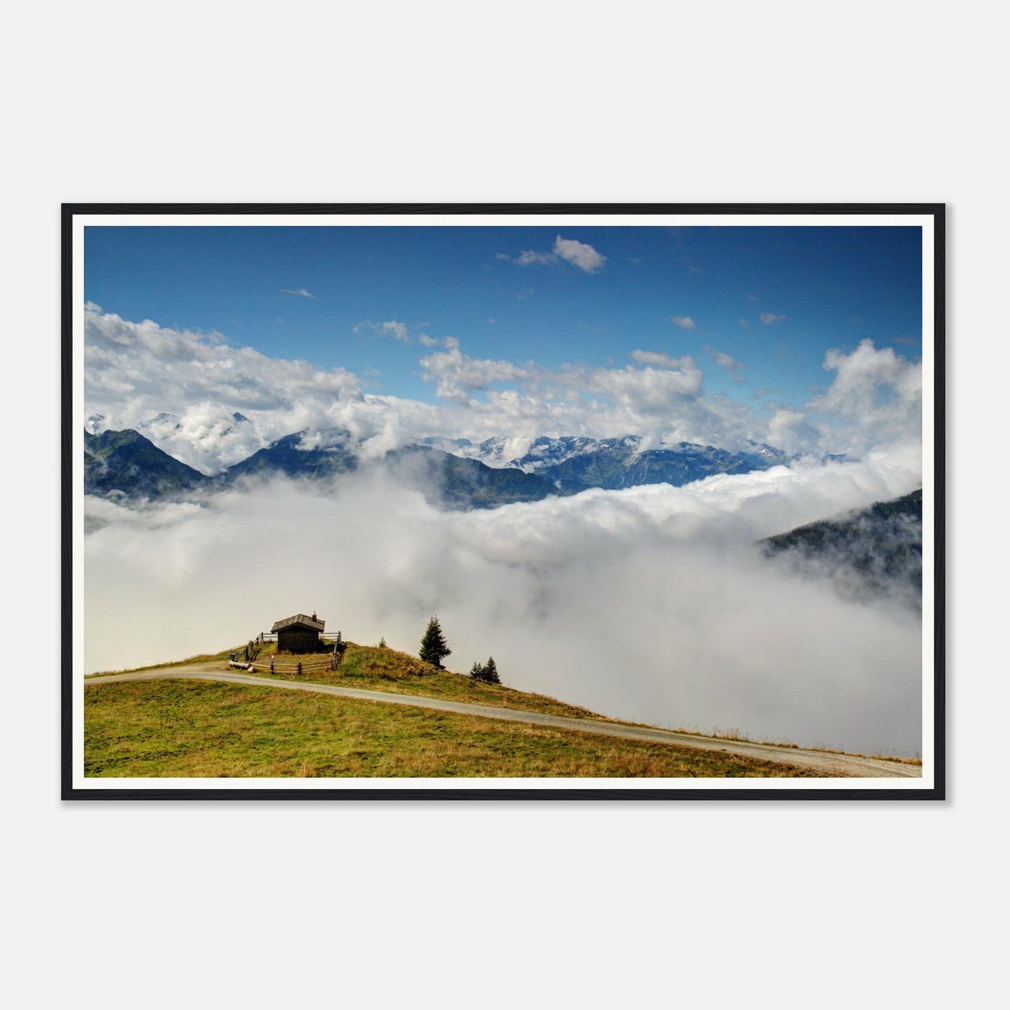 Solitary hut on verdant hilltop surrounded by clouds in Austria