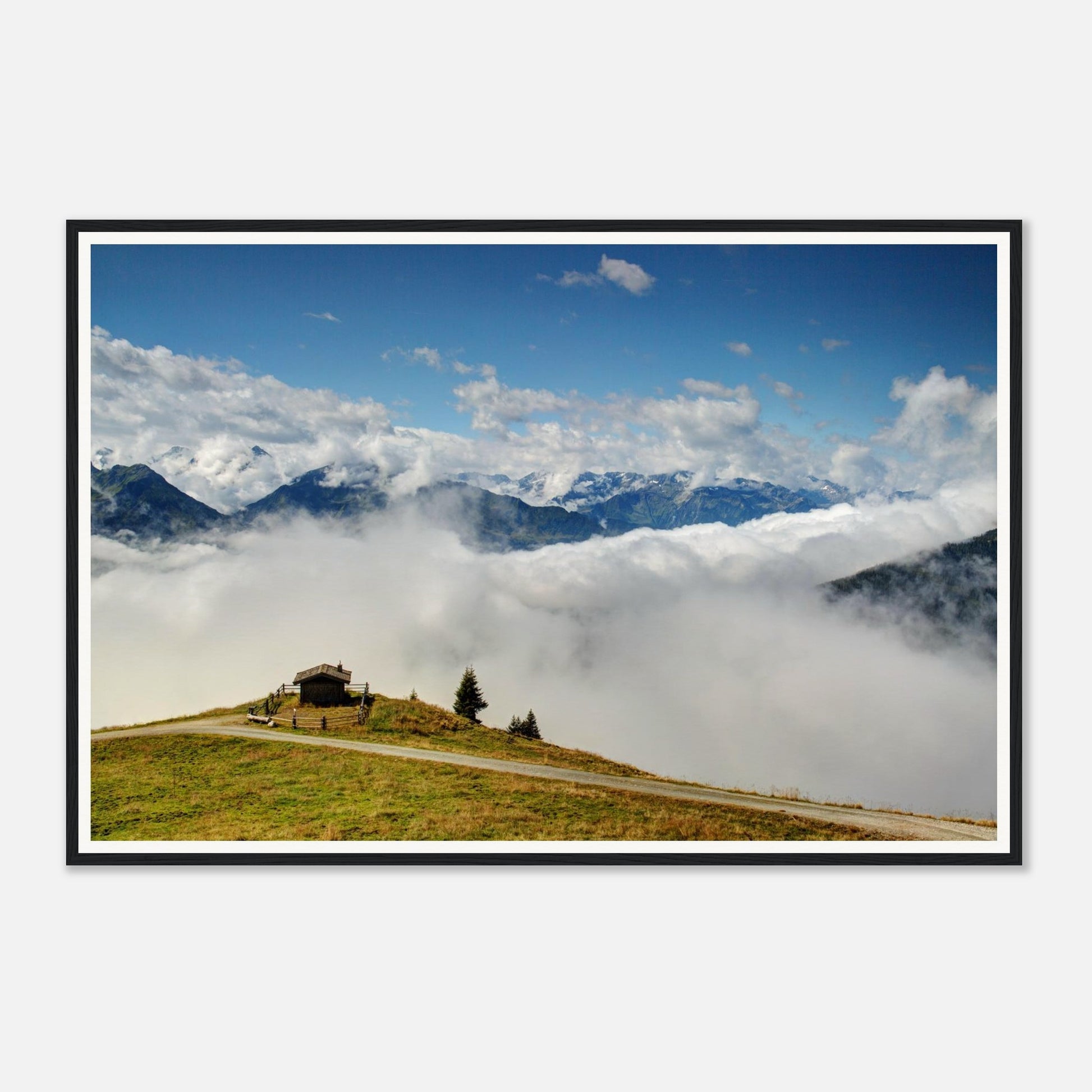 Solitary hut on verdant hilltop surrounded by clouds in Austria