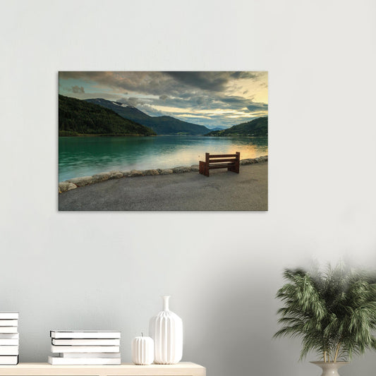Canvas print showing a lone wooden bench overlooking the tranquil waters of Innvikfjorden at sunset