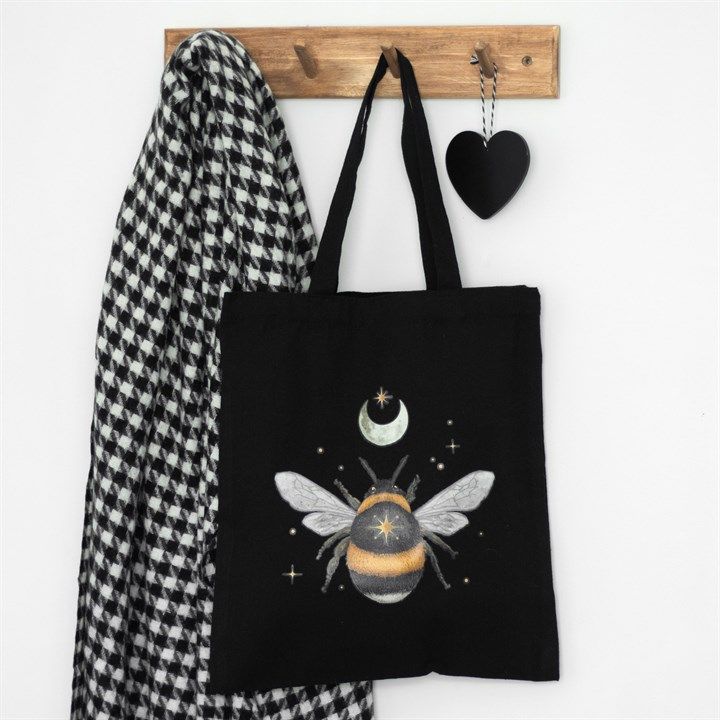 Black cotton canvas tote bag with a delicate forest bee design, perfect for everyday use or shopping.