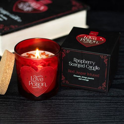 Love Potion candle with red jasper crystal chips and raspberry fragrance, designed to enhance courage and passion.