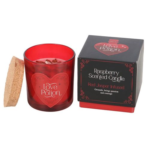 Love Potion candle with red jasper crystal chips and raspberry fragrance, designed to enhance courage and passion.