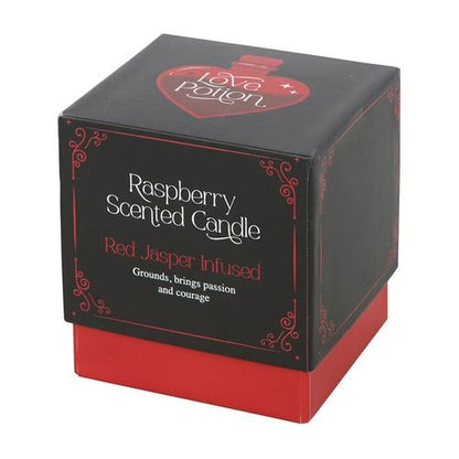 Love Potion candle with red jasper crystal chips and raspberry fragrance, designed to enhance courage and passion.