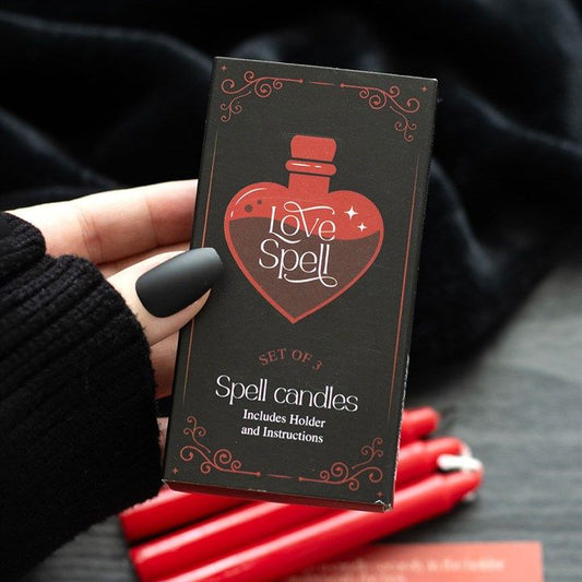 Love Potion candle with red jasper crystal chips and raspberry fragrance, designed to enhance courage and passion.