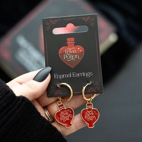 Gold-tone earrings with enamel love potion charms, a playful and romantic accessory.