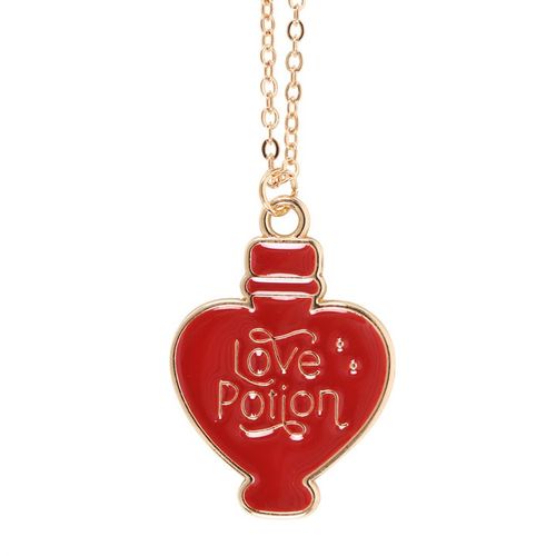 Gold-tone necklace with an enamel love potion charm, presented on a matching greeting card with an envelope.