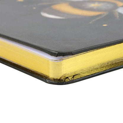 A5 notebook with mystical bee design, gold foil page edges, and ribbon marker.