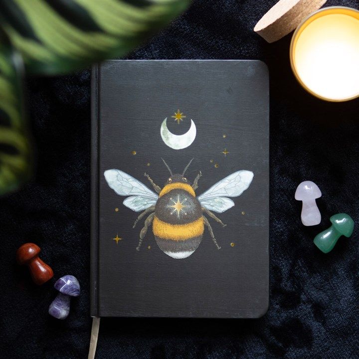 A5 notebook with mystical bee design, gold foil page edges, and ribbon marker.