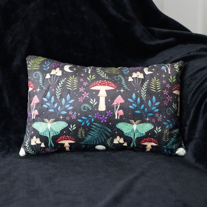 Printed cushion with forest motifs, including mystical mushrooms and moonlit moths, in dark botanical colours.