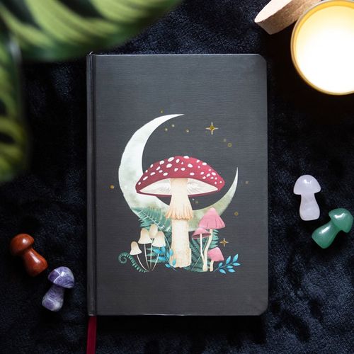 A5 notebook with mystical mushroom design, gold foil page edges, and ribbon marker.