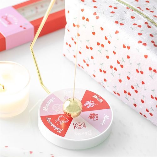 Pendulum Decision Maker for Date Night with gold-tone pendulum and six activity outcomes in pink and red colours.