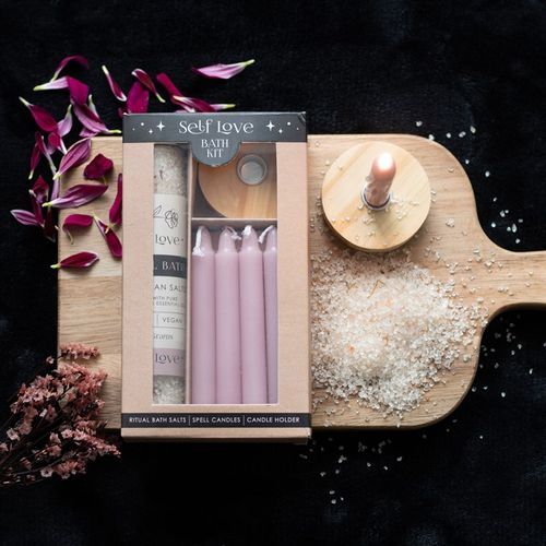 Self Love Ritual Bath Kit featuring Himalayan salt bath salts, ylang ylang essential oil, pink spell candles, and a wooden holder for a nurturing, healing ritual.