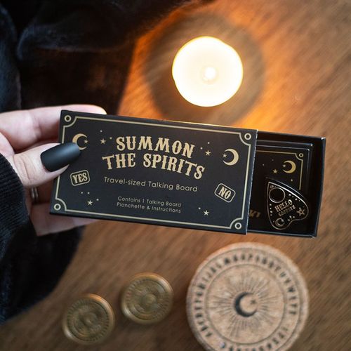 Travel-sized black and gold talking board with mini spirit board and planchette, designed for light-hearted entertainment.