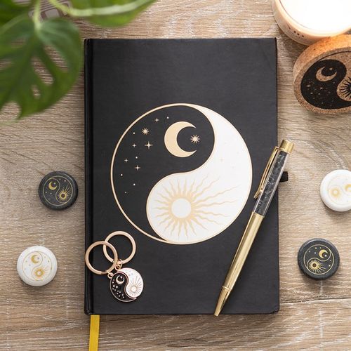 Celestial Yin and Yang journal with obsidian chip pen, gold ribbon bookmark, and gold foil-edged pages.