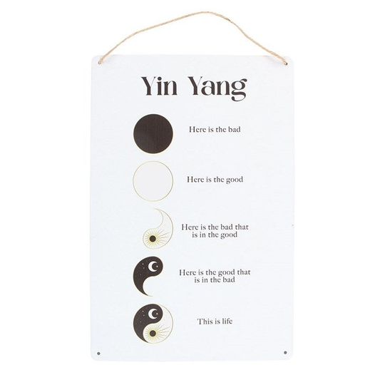 Hanging metal sign with a minimalist yin and yang design symbolising balance.